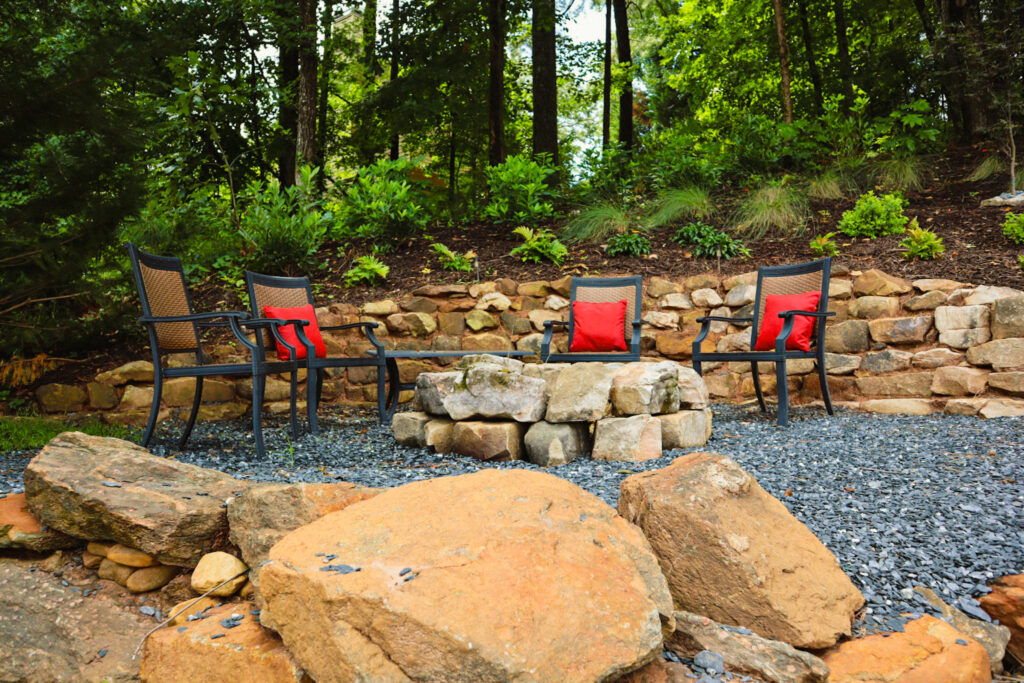 Outdoor seating with red cushions by fire pit